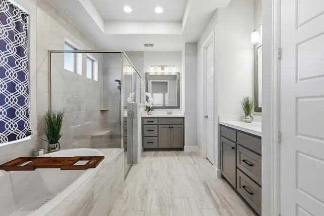 a bathroom with a sink a large mirror and a shower