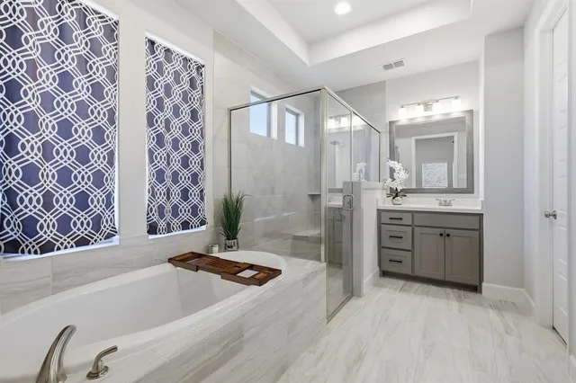 a bathroom with a tub sink and mirror