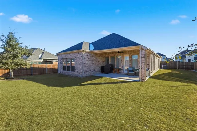 a view of house with yard and swimming pool
