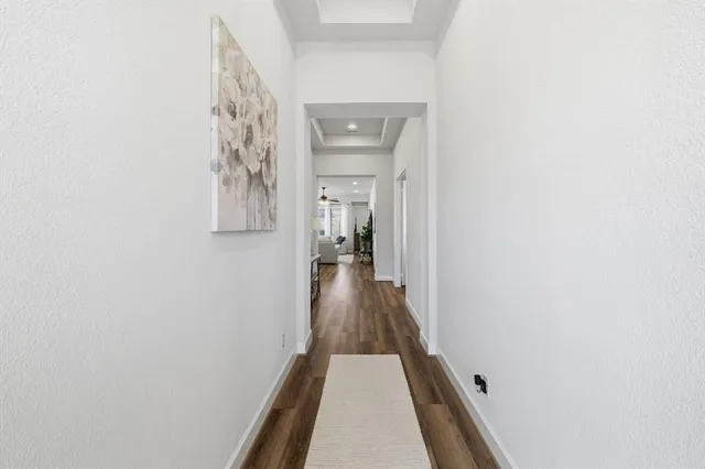 a view of a hallway view with wooden floor and staircase