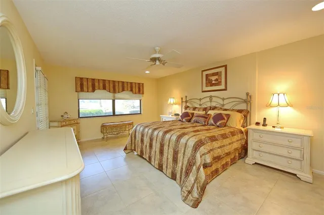 a bedroom with a bed and a night stand