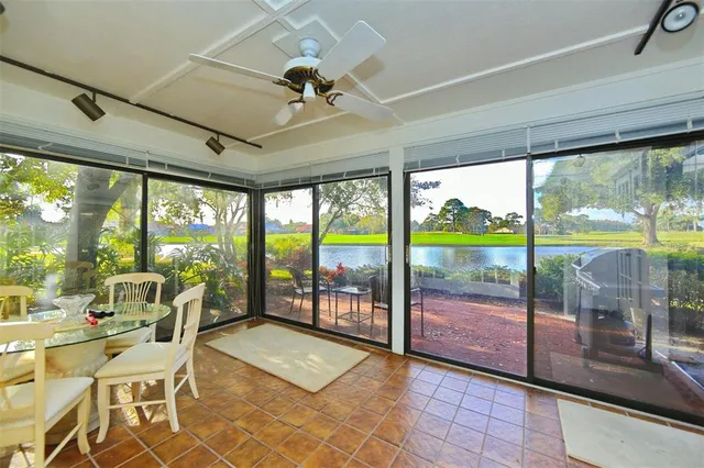 a view of a dining room with furniture water view and a floor to ceiling window