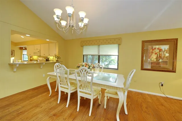 a view of a dining room with furniture and chandelier