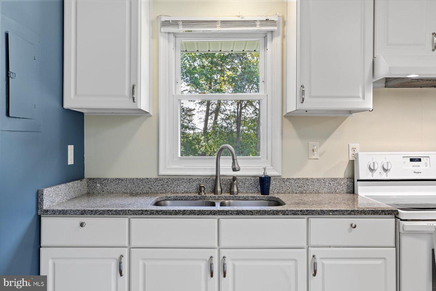 11193 Henry Griffin Road King George, VA 22485 - Photo 22 of 35 a kitchen with granite countertop white cabinets and a window