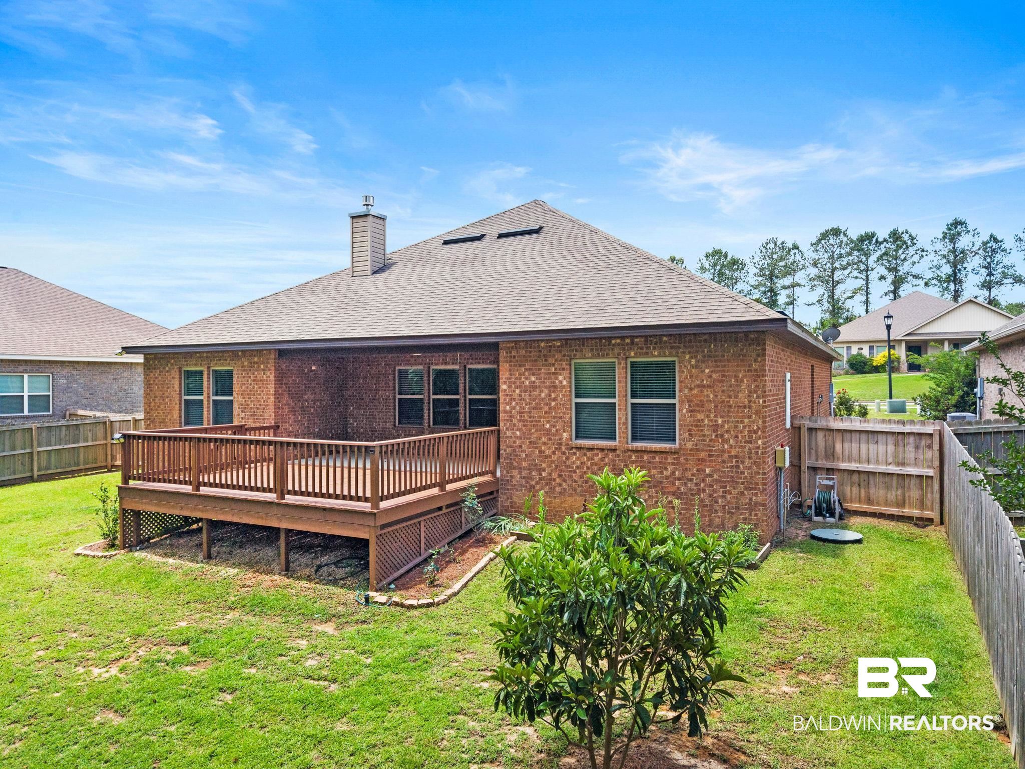31350 Hoot Owl Road Daphne, AL 36527 - Photo 84 of 94 Expansive brick exterior with a wood-finish deck and railing