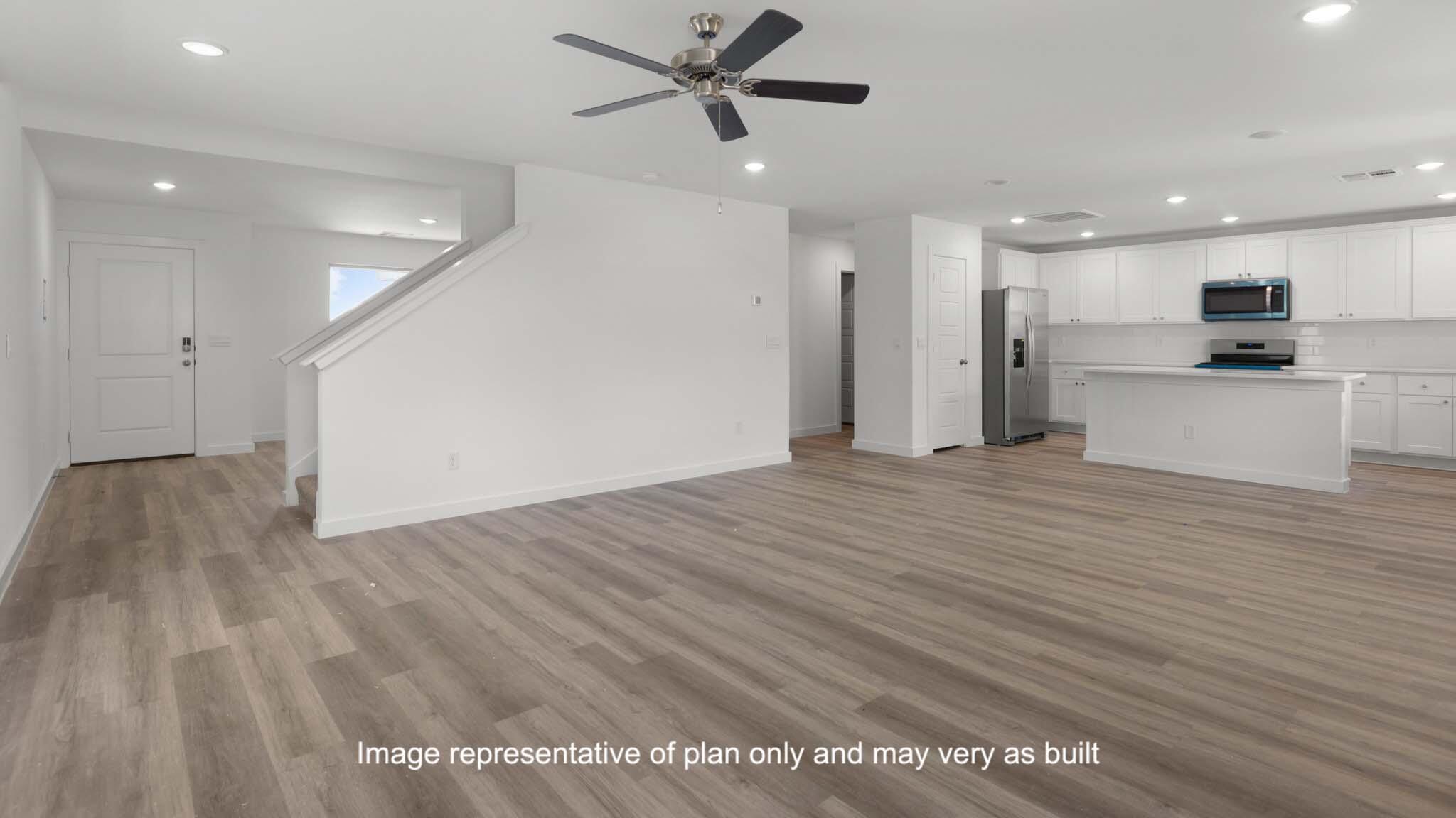 7443 9th Street Lubbock, TX 79416 - Photo 7 of 28 a view of a kitchen with kitchen island wooden floor appliances and a window