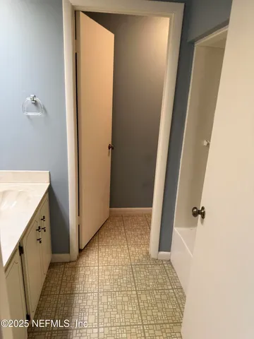 a bathroom with a sink a toilet a mirror and window