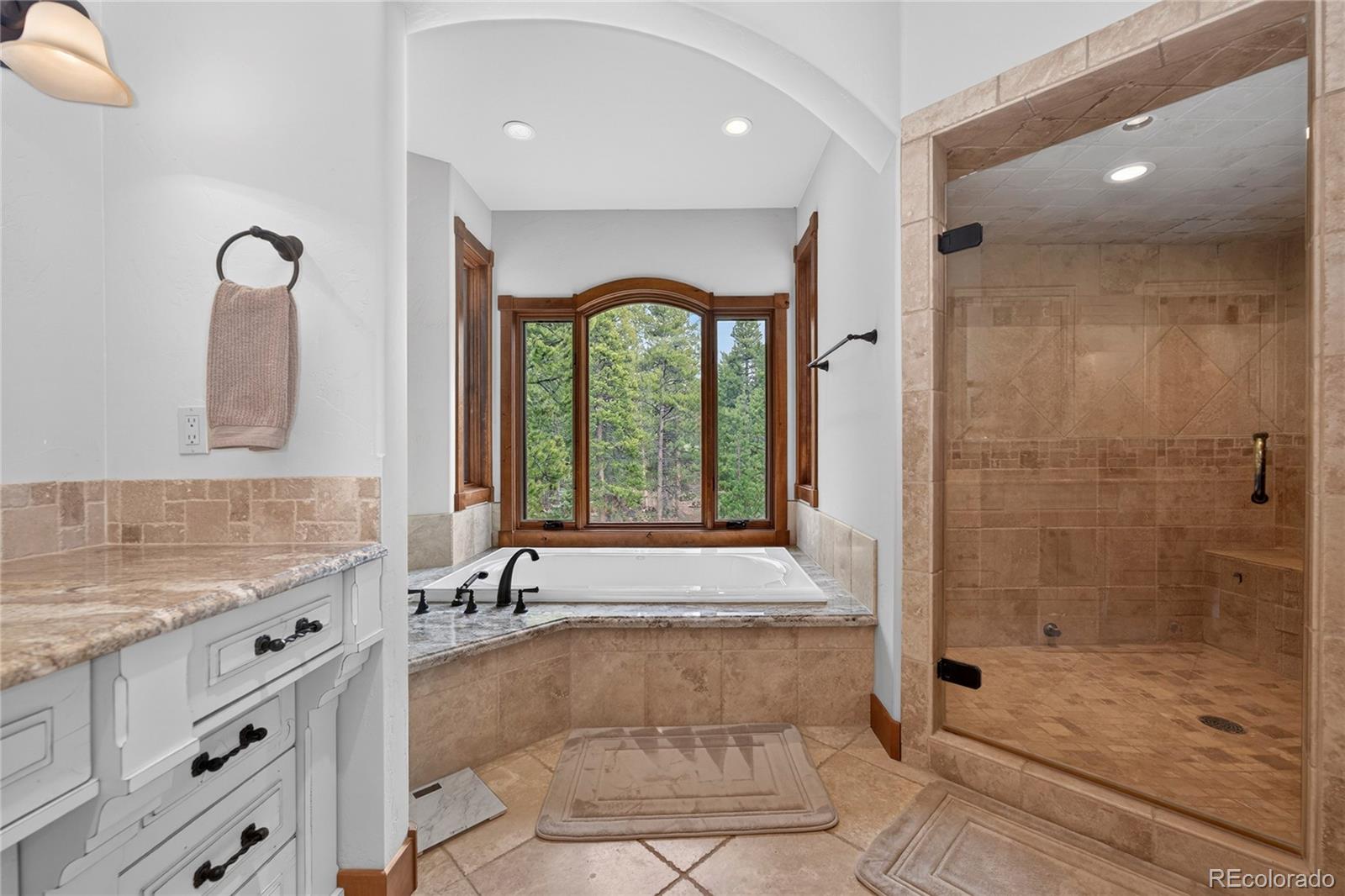 148 County Road Tabernash, CO 80478 - Photo 24 of 45 a bathroom with a granite countertop bathtub shower sink and mirror