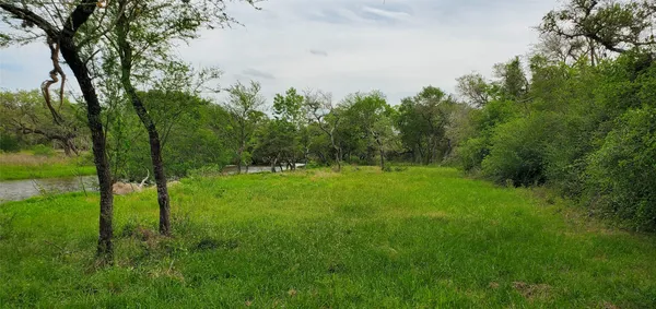 a view of a lake with green space