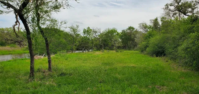 a view of a lake with green space