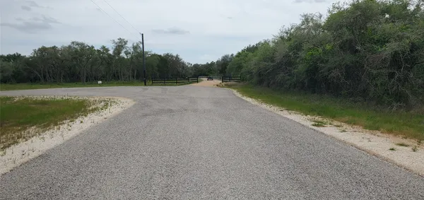 a view of field with trees in the background