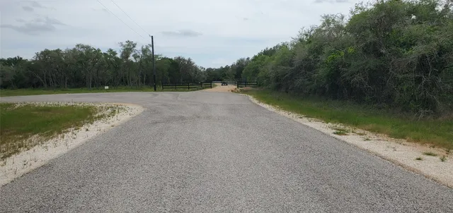 a view of field with trees in the background