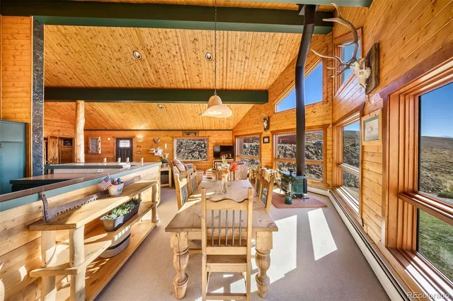 a view of a balcony with dining table and chairs with wooden floor