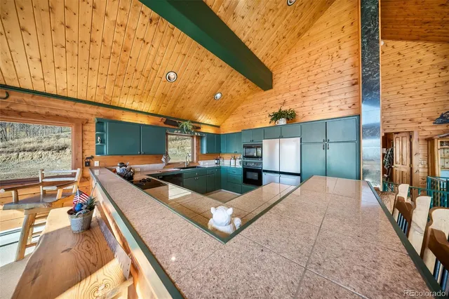 a kitchen with stainless steel appliances a refrigerator sink and cabinets