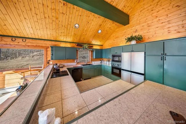 a kitchen with a sink and large cabinets