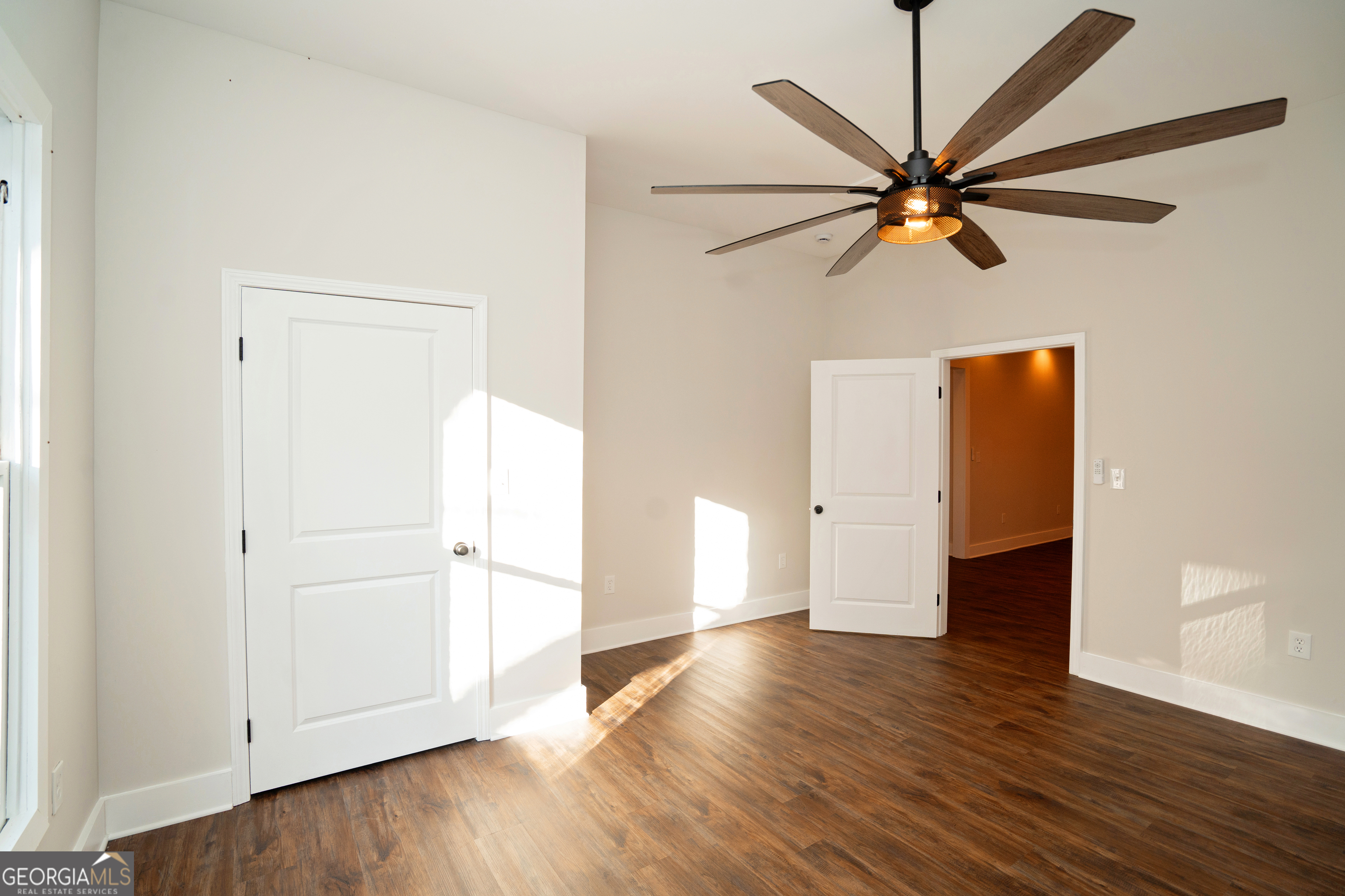 269 Martin Dairy Road Milner, GA 30257 - Photo 11 of 71 an empty room with wooden floor closet and fan