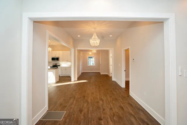 a large kitchen with kitchen island granite countertop a window and a white cabinets