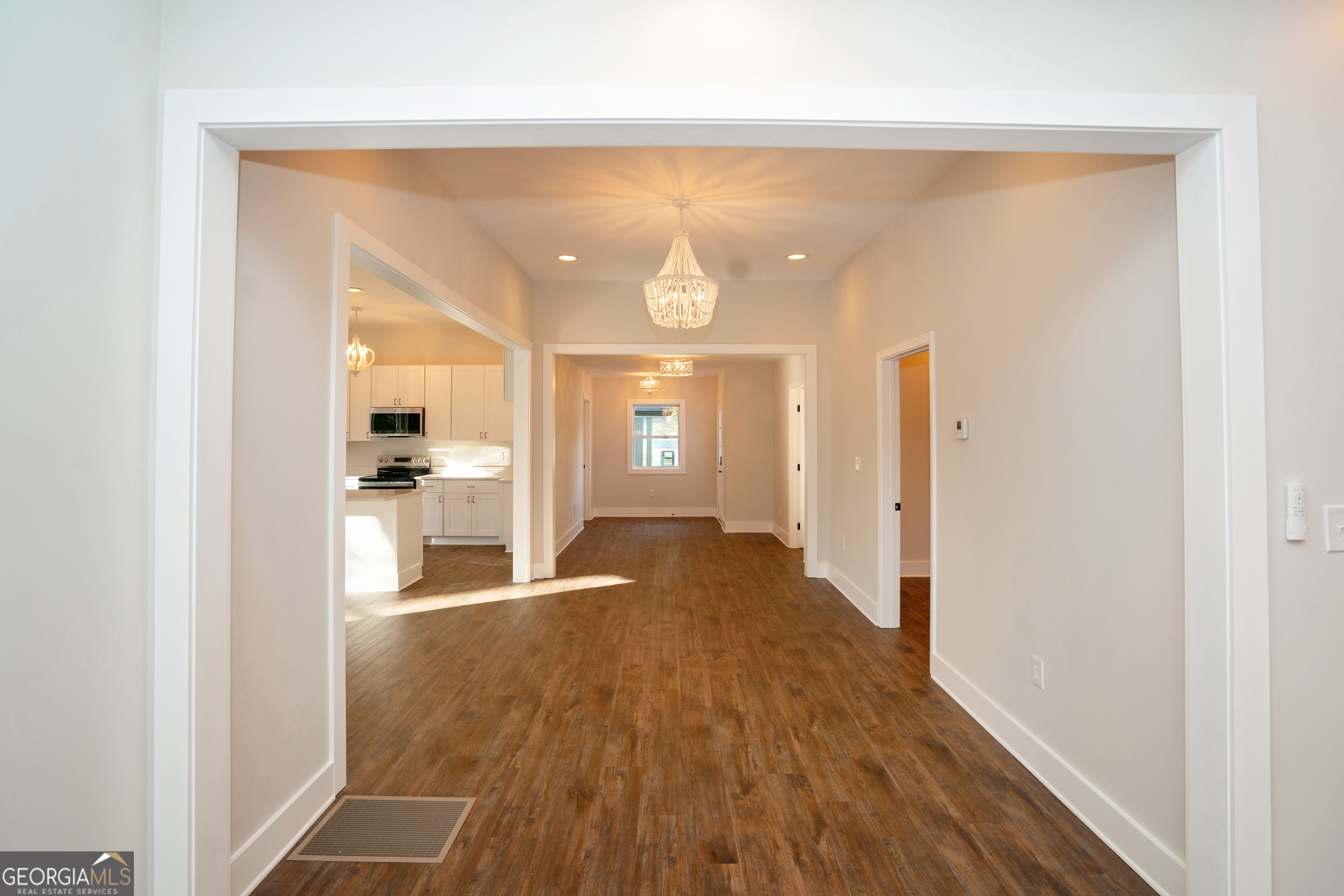 269 Martin Dairy Road Milner, GA 30257 - Photo 12 of 71 a view of a hallway with wooden floor and a living room