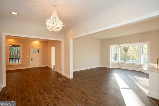 a kitchen with granite countertop white cabinets and stainless steel appliances