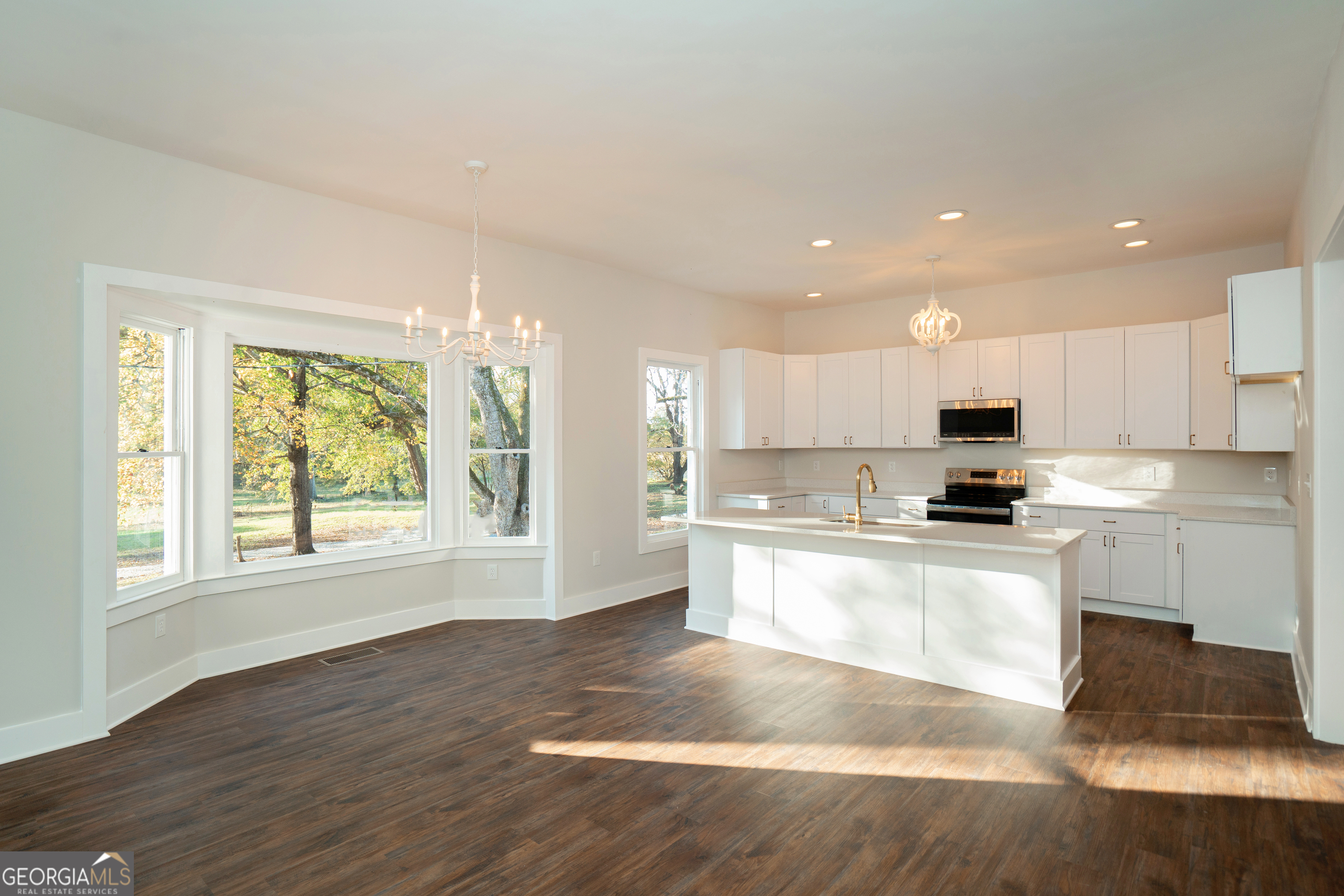 269 Martin Dairy Road Milner, GA 30257 - Photo 17 of 71 a large kitchen with kitchen island granite countertop a window and a white cabinets