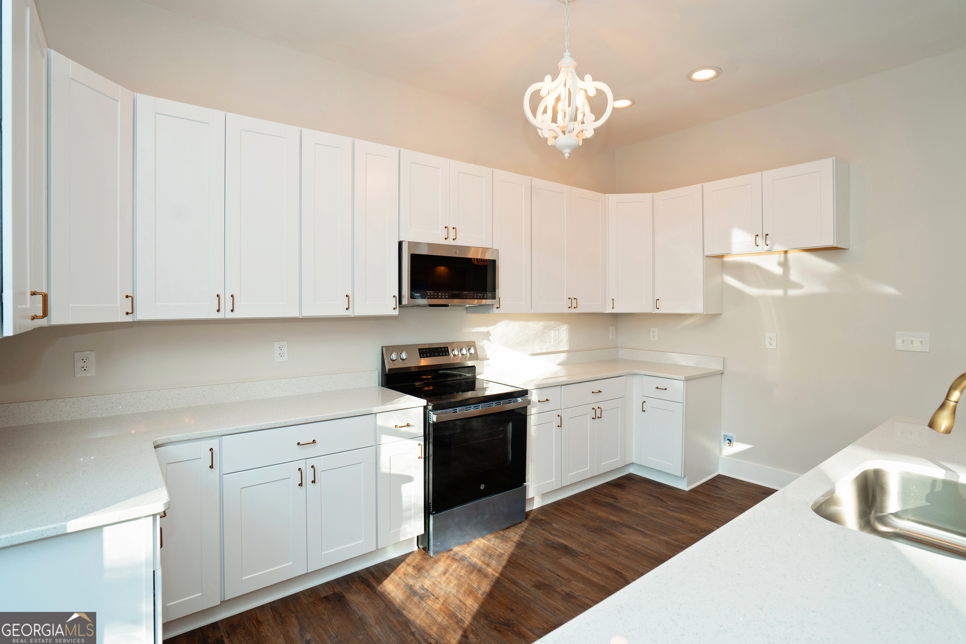269 Martin Dairy Road Milner, GA 30257 - Photo 21 of 71 a kitchen with granite countertop white cabinets and stainless steel appliances