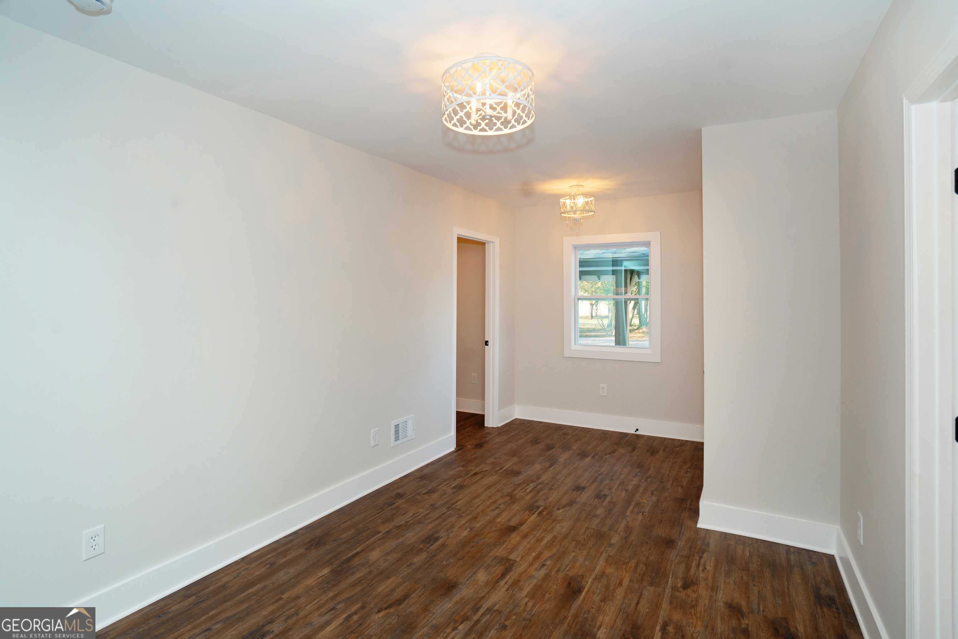 269 Martin Dairy Road Milner, GA 30257 - Photo 24 of 71 a view of an empty room with window and wooden floor