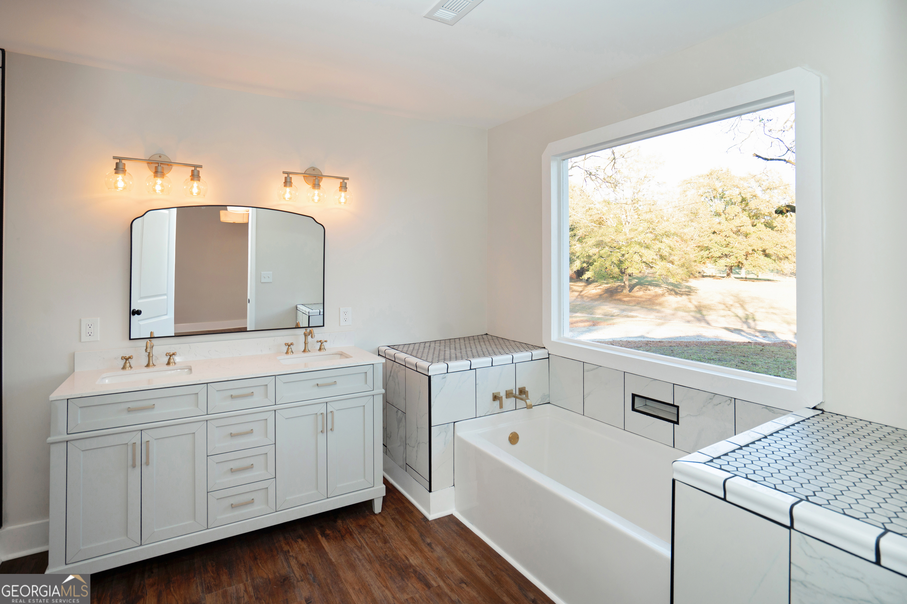 269 Martin Dairy Road Milner, GA 30257 - Photo 29 of 71 a spacious bathroom with a double vanity sink a mirror and a bathtub