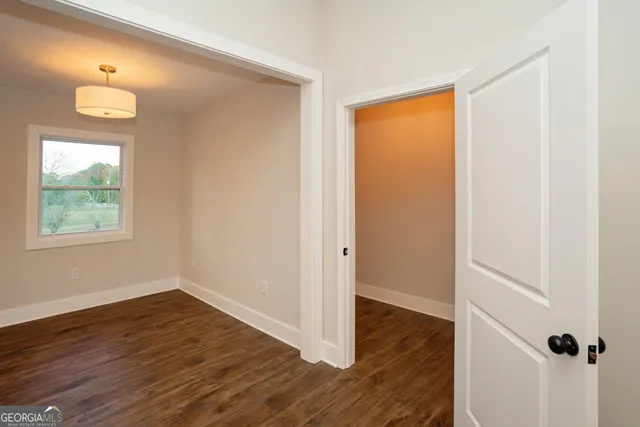 a view of dirt yard with large trees