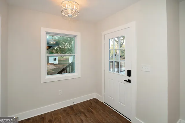 a front view of a house with a yard and trees