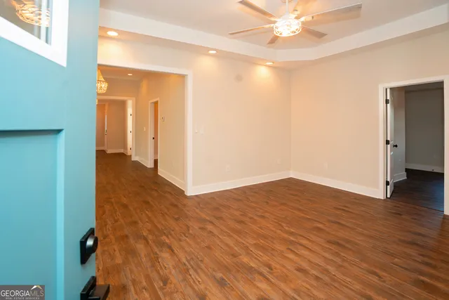 a view of an empty room and wooden floor
