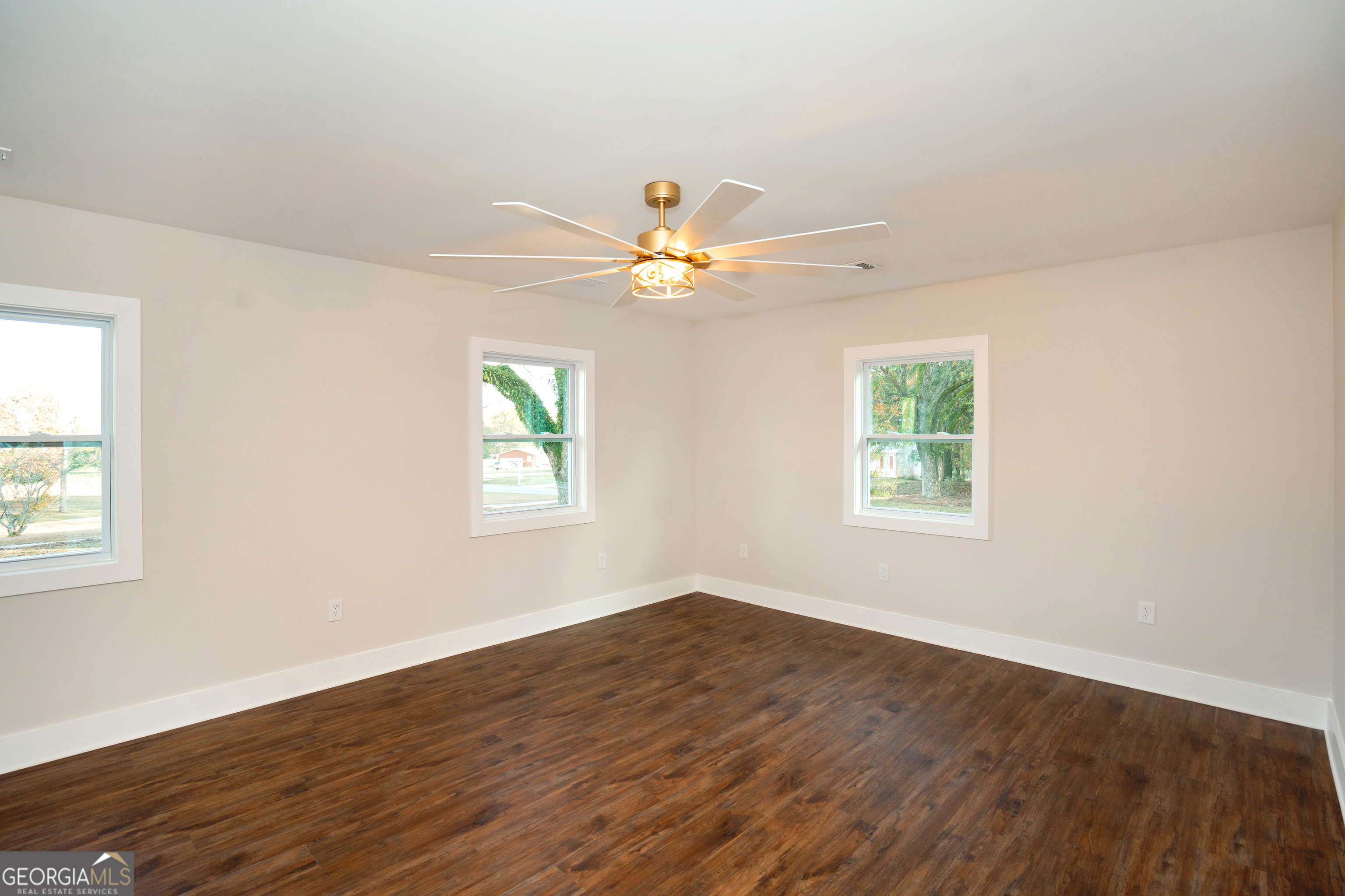 269 Martin Dairy Road Milner, GA 30257 - Photo 8 of 71 a view of an empty room with wooden floor and a window