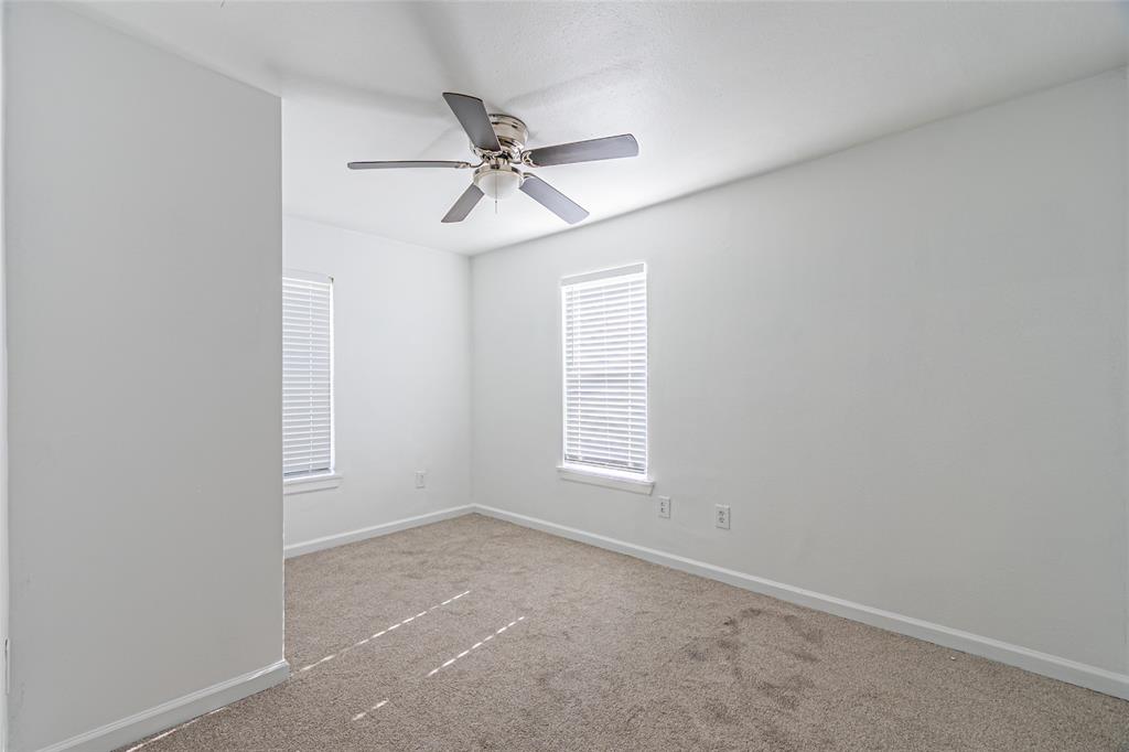 605 Lloyd Italy, TX 76651 - Photo 12 of 30 an empty room with windows and fan