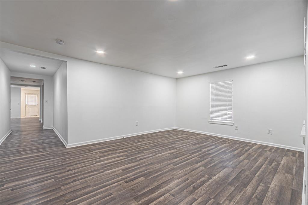 605 Lloyd Italy, TX 76651 - Photo 5 of 30 wooden floor in an empty room with a window