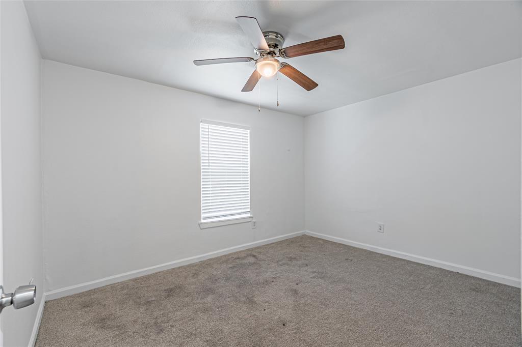 605 Lloyd Italy, TX 76651 - Photo 9 of 30 an empty room with a ceiling fan and windows