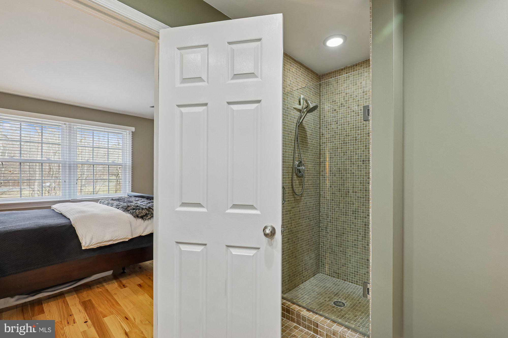 8019 Galla Knoll Circle Springfield, VA 22153 - Photo 30 of 57 a en suite bathroom with a granite countertop sink a mirror and a shower