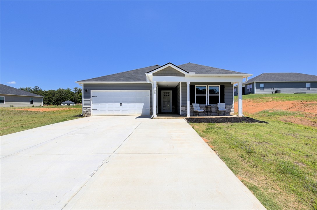 A welcoming front porch with stately columns graces this modern ranch home.