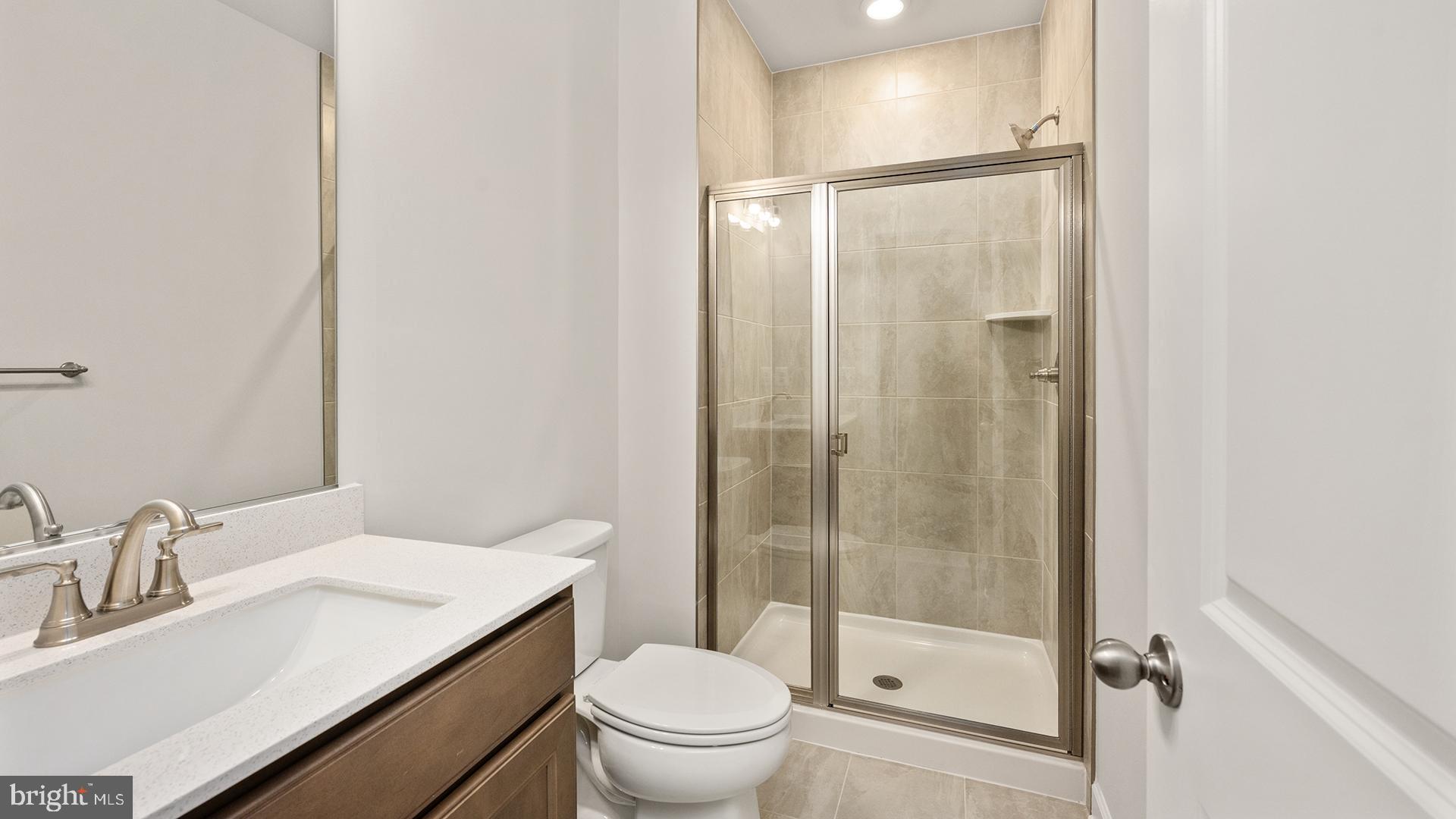 14018 Northern Vw Road Culpeper, VA 22701 - Photo 26 of 27 a bathroom with a shower sink vanity mirror and toilet