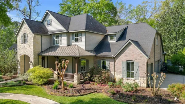 a front view of a house with a yard porch and outdoor seating