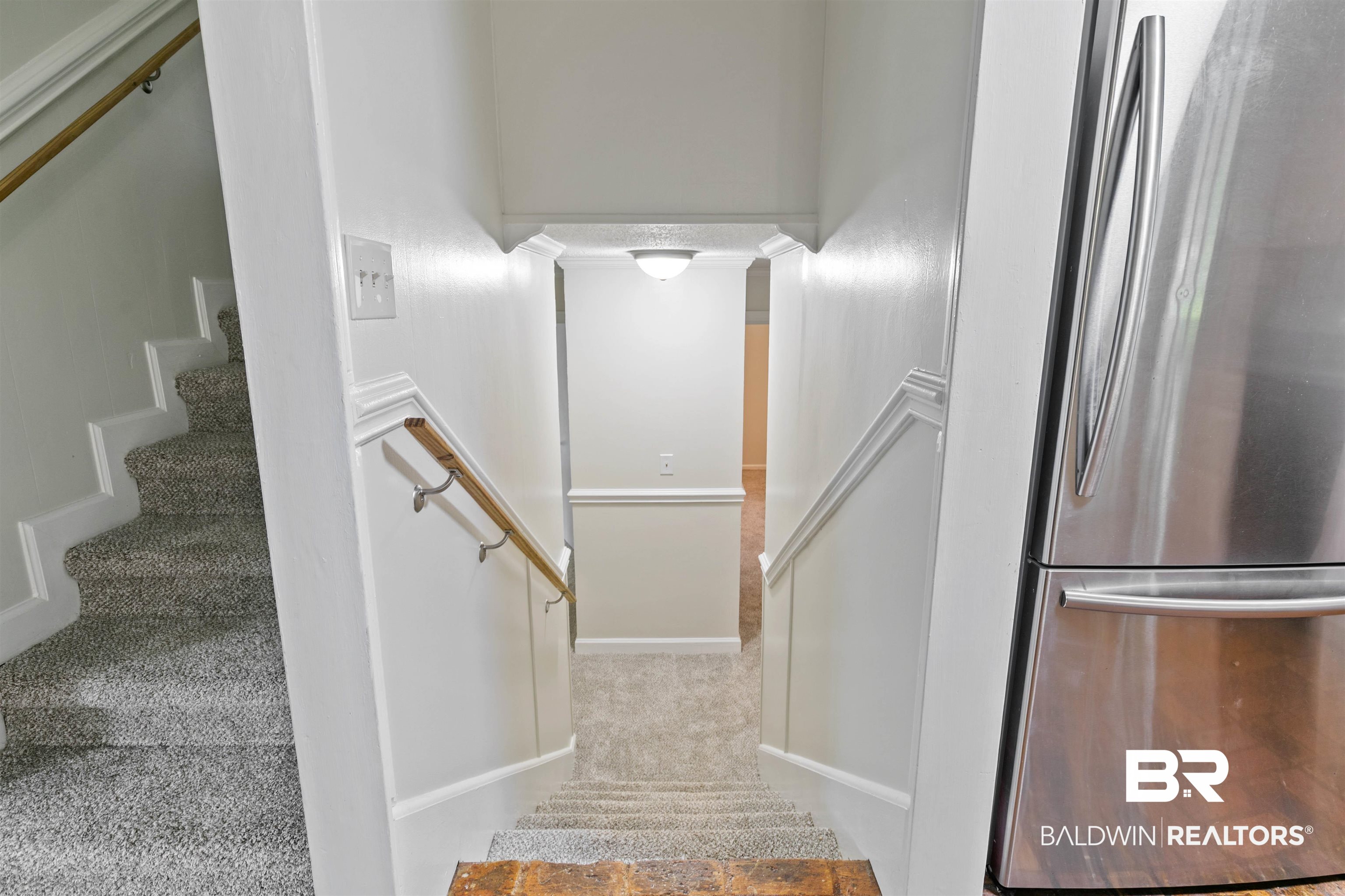 10420 Johnson Road South Mobile, AL 36695 - Photo 31 of 75 Staircase with carpeted treads and white risers, featuring a wood handrail