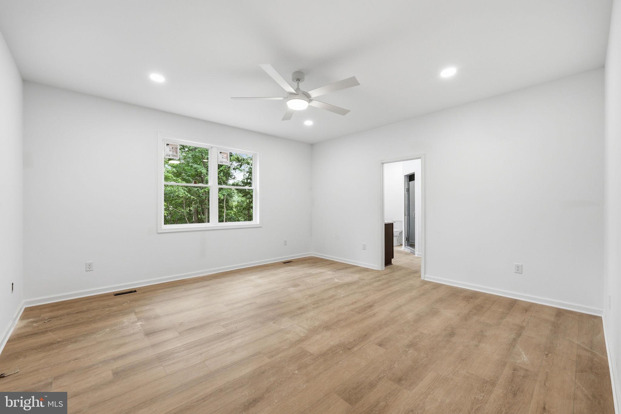 10339 Back Creek Valley Road Hedgesville, WV 25427 - Photo 21 of 48 an empty room with a window and a ceiling fan