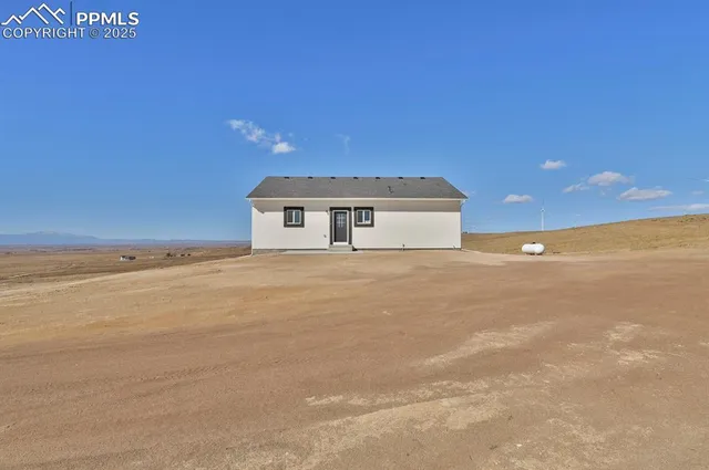 a view of house with yard and ocean view