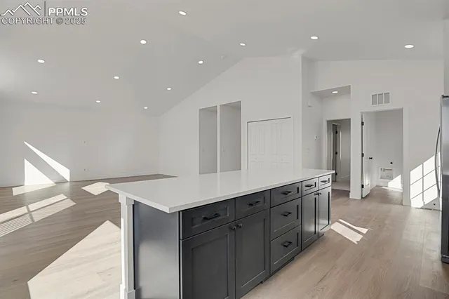 a kitchen with stainless steel appliances a sink and a refrigerator