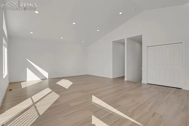 a view of empty room with wooden floor
