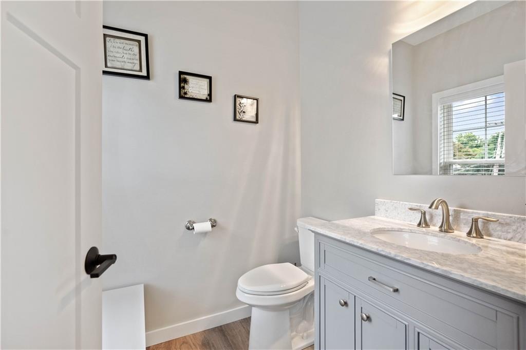 414 Friday Road Pittsburgh, PA 15209 - Photo 11 of 24 a bathroom with a granite countertop toilet sink and mirror