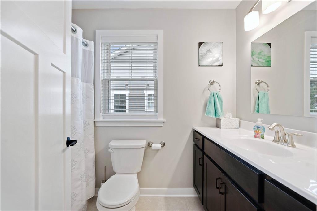 414 Friday Road Pittsburgh, PA 15209 - Photo 18 of 24 a bathroom with a toilet a sink a mirror a window and vanity