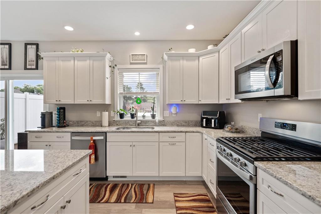 414 Friday Road Pittsburgh, PA 15209 - Photo 10 of 24 a kitchen with stainless steel appliances granite countertop a stove a sink and a microwave