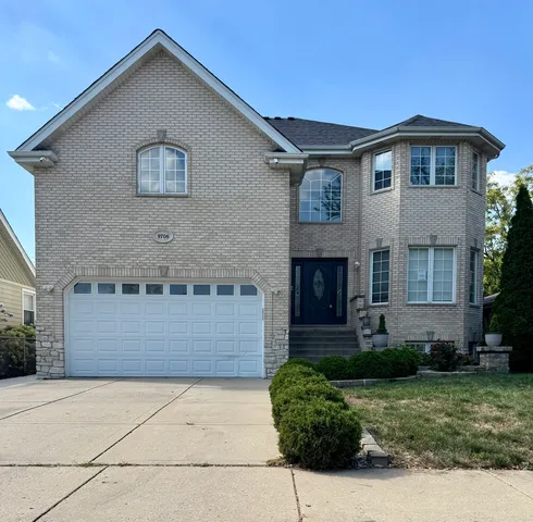a front view of a house with a yard and garage