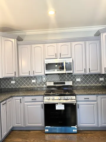 a kitchen with stainless steel appliances granite countertop a stove and a sink