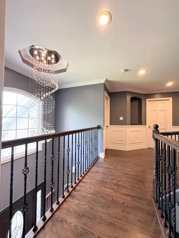 a view of a hallway with chandelier