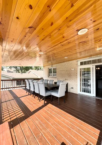 a view of balcony with wooden floor and outdoor seating